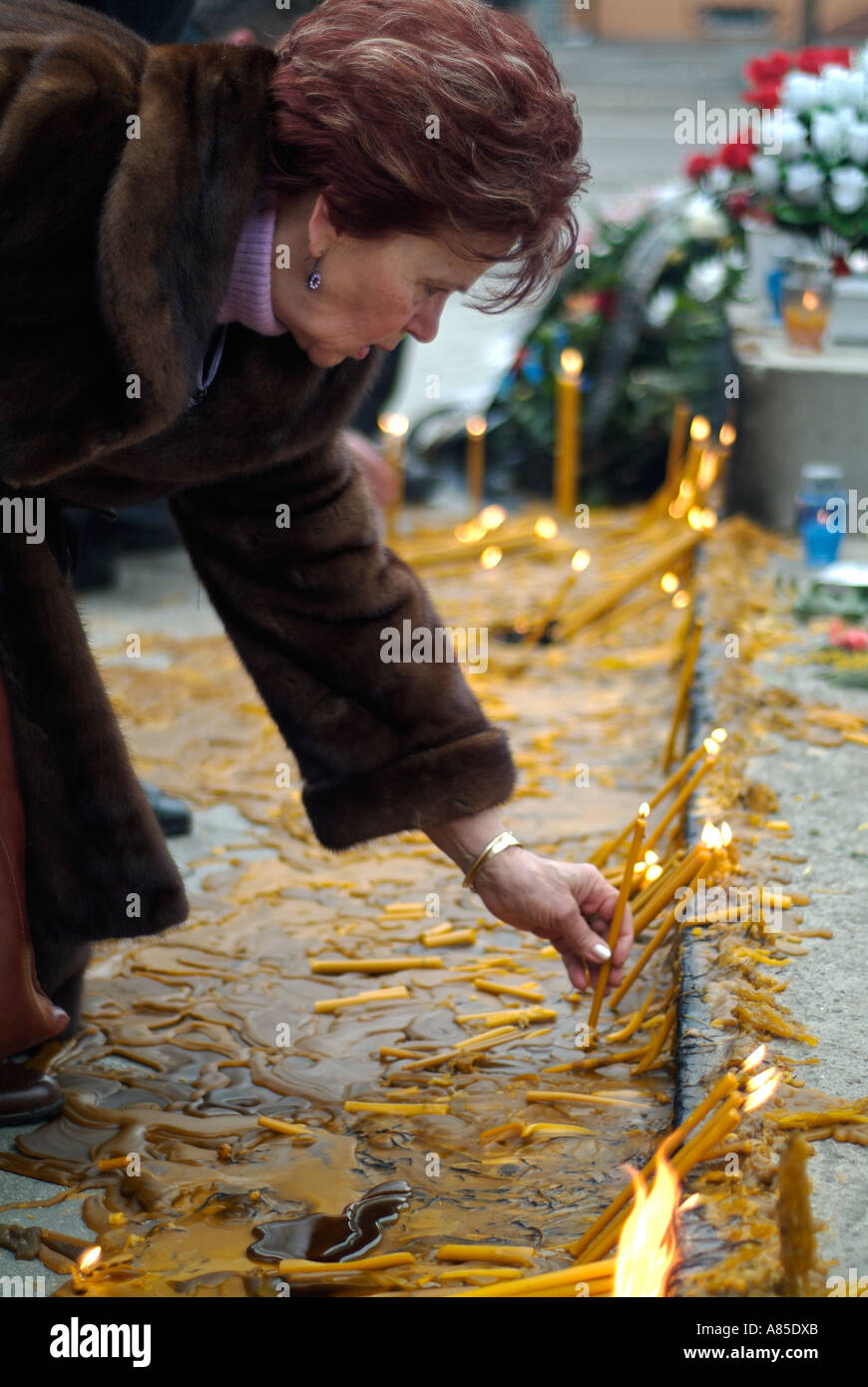 Bosnian Serb woman lights a candle at a memorial to Slobodan Milosevic in Banja Luka city centre Republika Srpska Bosnia Herzego Stock Photo