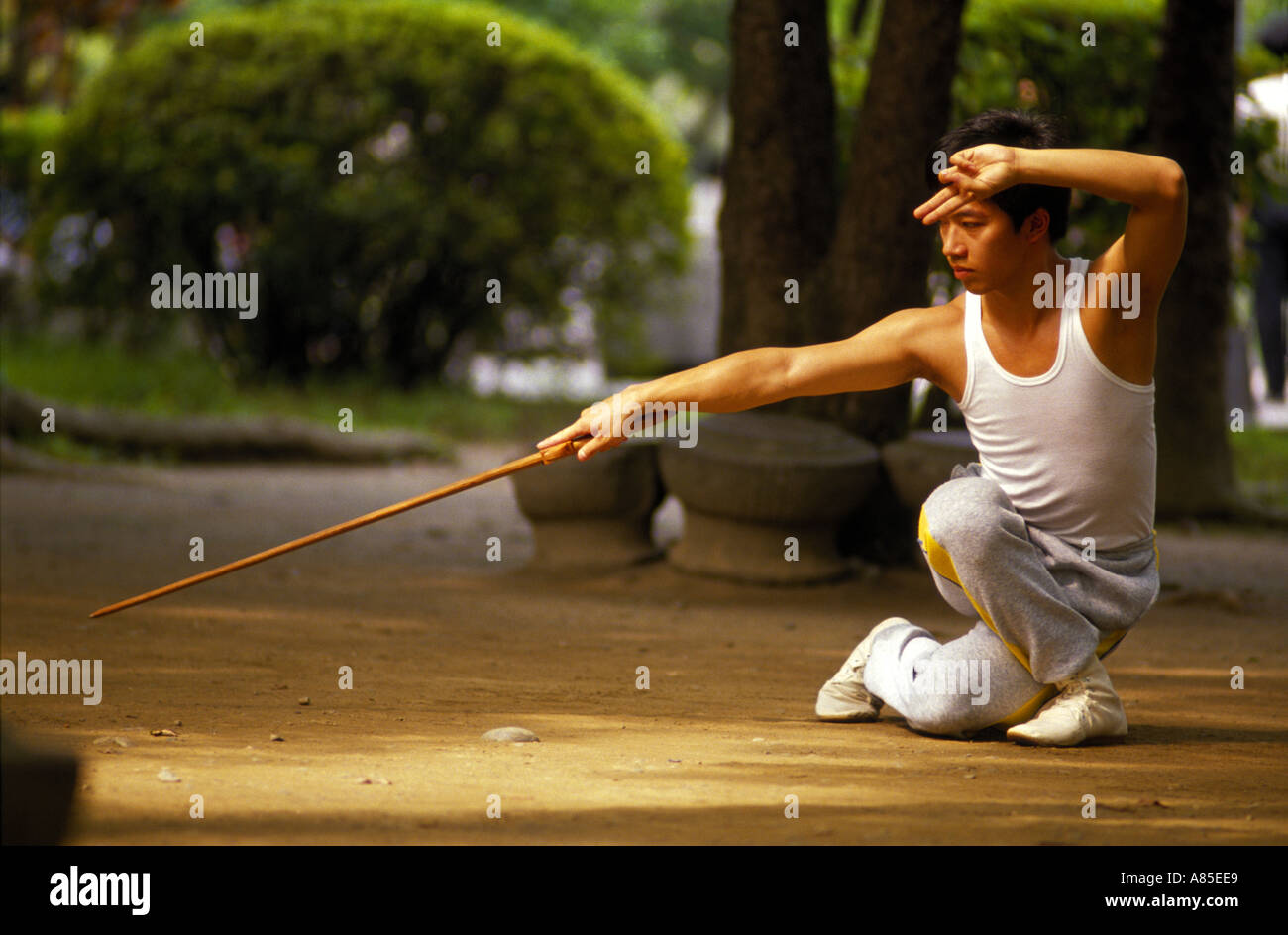 Morning execise chinese practised Kung Fu with a wooden sword in Stock