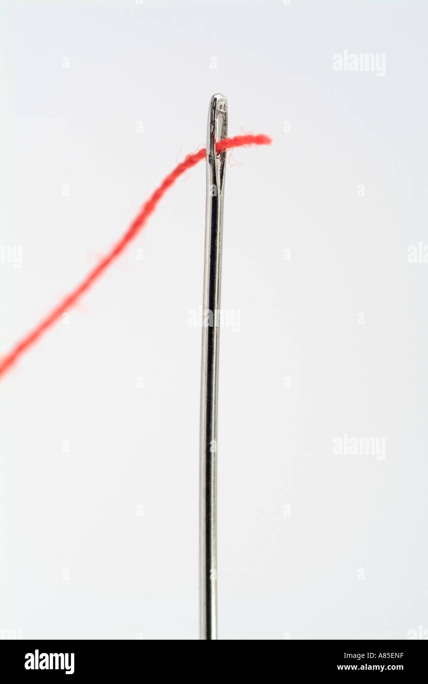 Needle threaded with red thread hi-res stock photography and images - Alamy