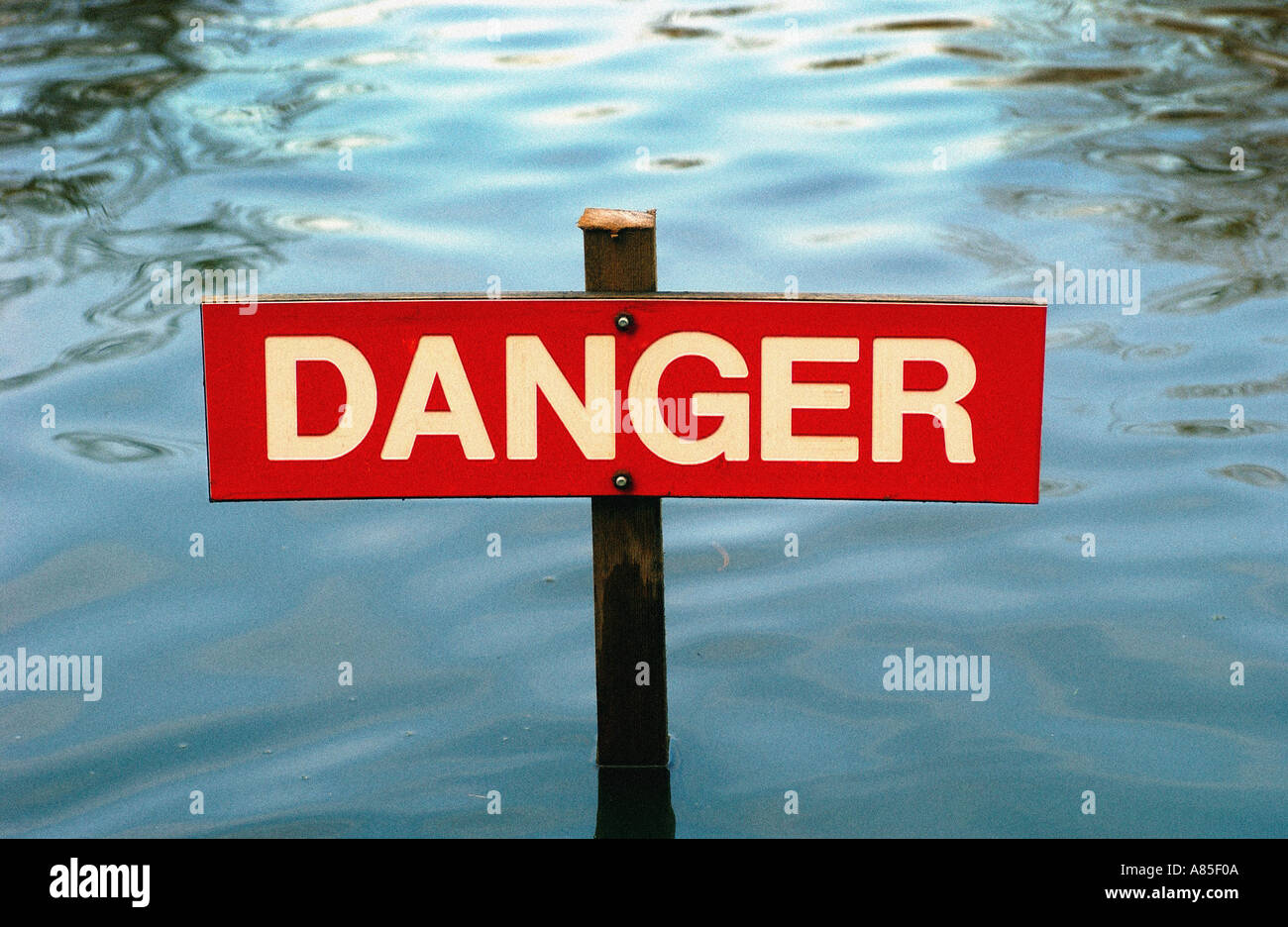 Danger Sign on post in water Stock Photo
