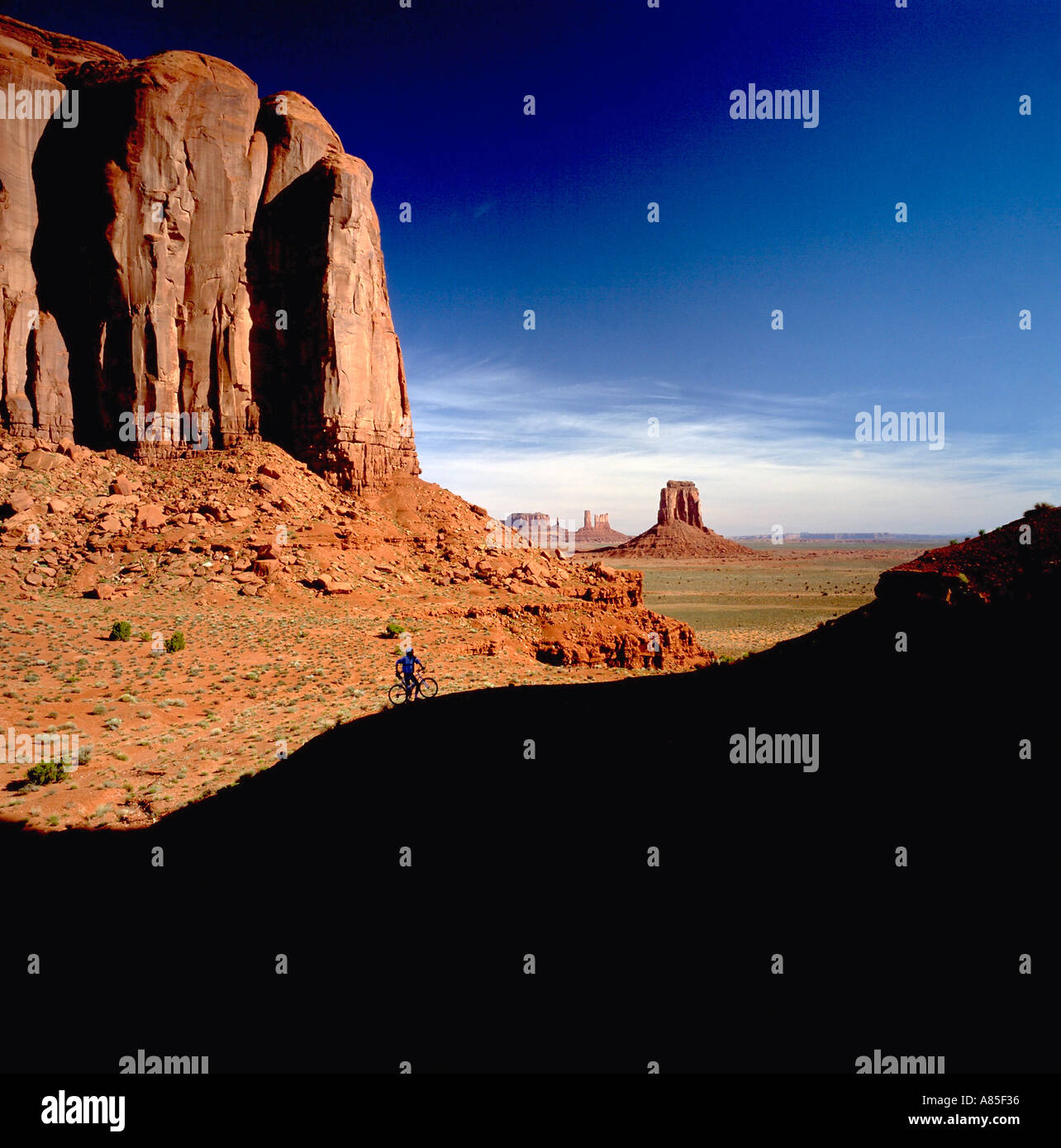 Bicyclist silhouetted in Monument Valley Arizona Stock Photo