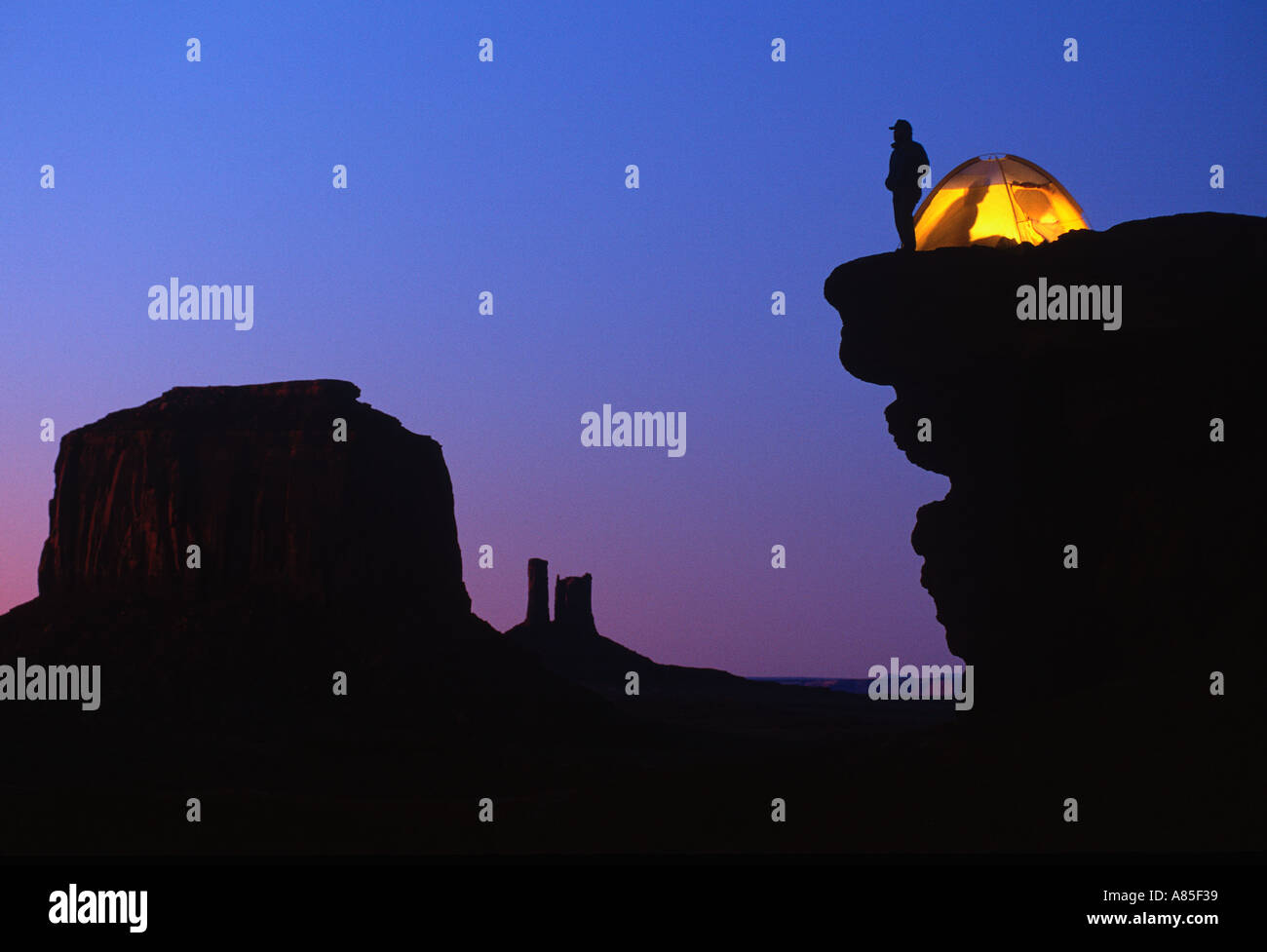 Camper enjoys the view from his campsite on a cliff overlooking Monument Valley Arizona - Utah Stock Photo