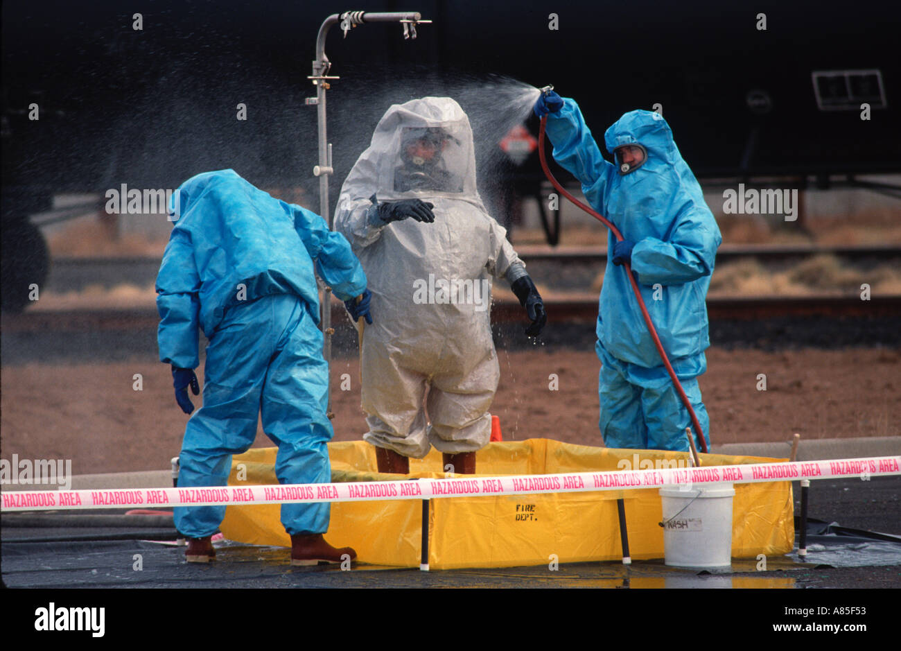 Emergency response hazardous waste team washes off contaminants after a spill Stock Photo