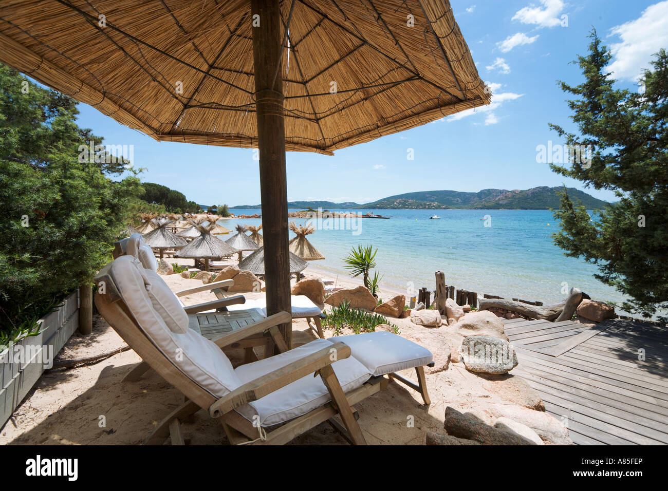 Sun Loungers on the beach at the Grand Hotel Cala Rossa near Porto Vecchio, Corsica, France Stock Photo