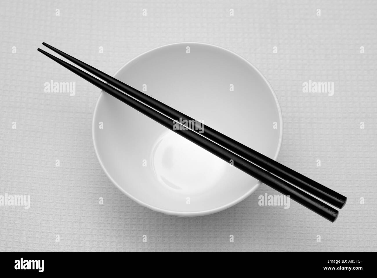 Chopsticks on an Empty Rice Bowl Stock Photo