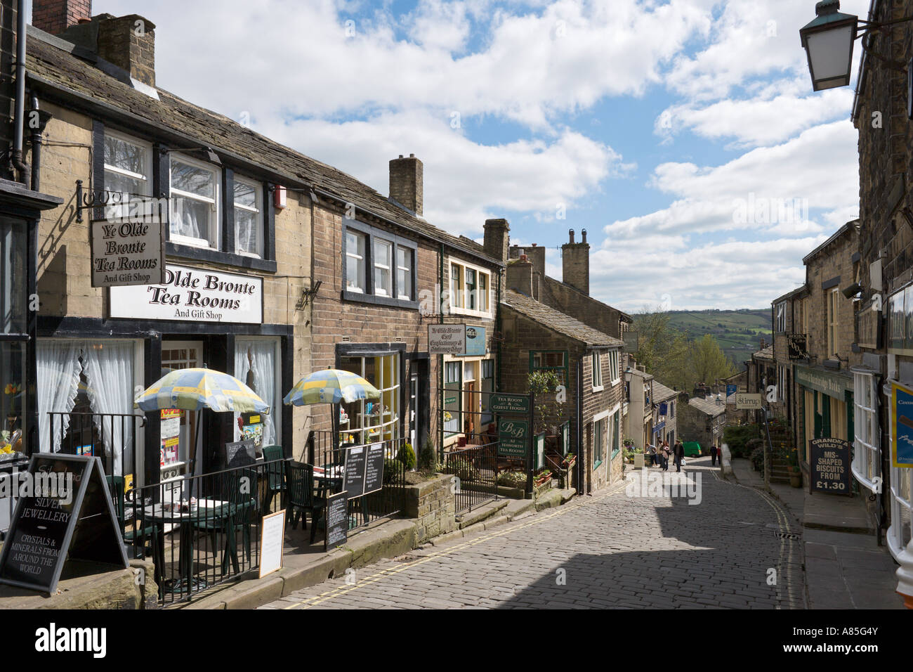 Shops and Ye Olde Bronte Tea Rooms on the main street in the village centre, Haworth, West Yorkshire, England, UK Stock Photo