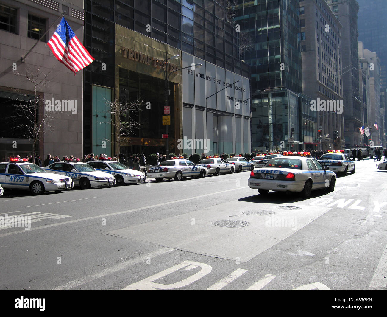 Police patrol cars on fifth avenue with american flag flying, New York