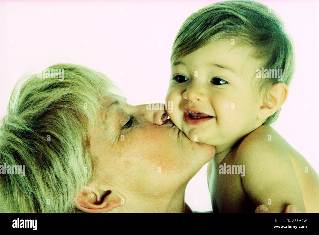 GRANDMOTHER KISSING GRANDSON ON CHEEK Stock Photo