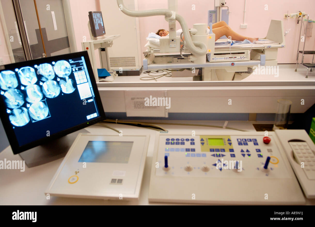 Woman having barium enema on table of Siemens Medical Solutions Axiom