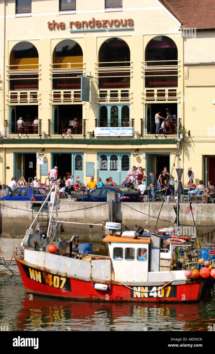 View over quayside with THE RENDEZVOUS public house on the harbour at Weymouth Dorset England UK Stock Photo