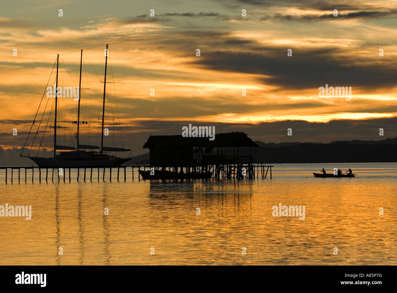 Sunset view of a sailing boat anchored on Kri Island, Raja Ampat Indonesia. Stock Photo