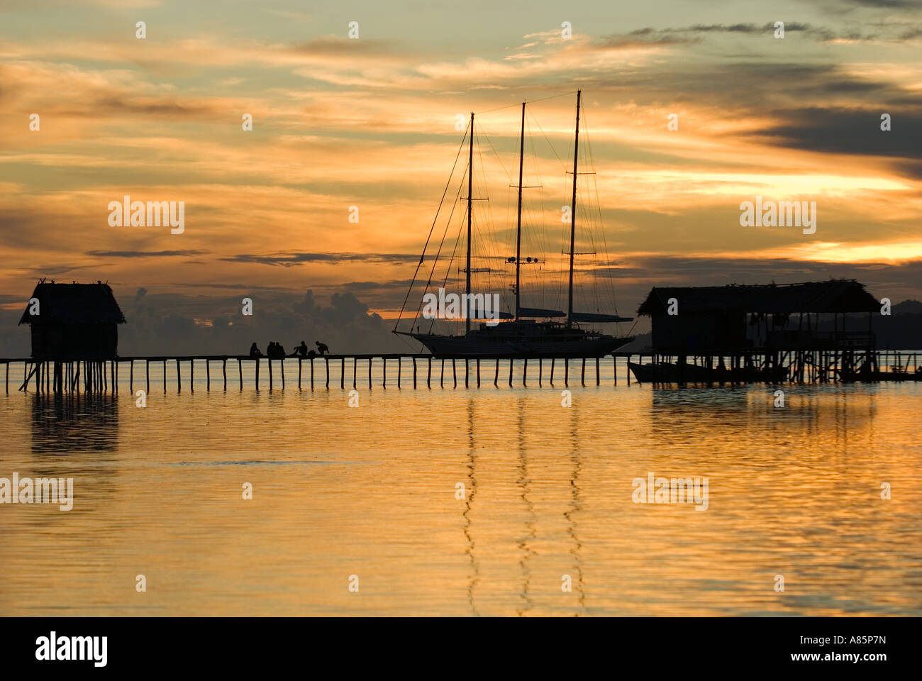 Sunset view of a sailing boat anchored on Kri Island, Raja Ampat Indonesia. Stock Photo