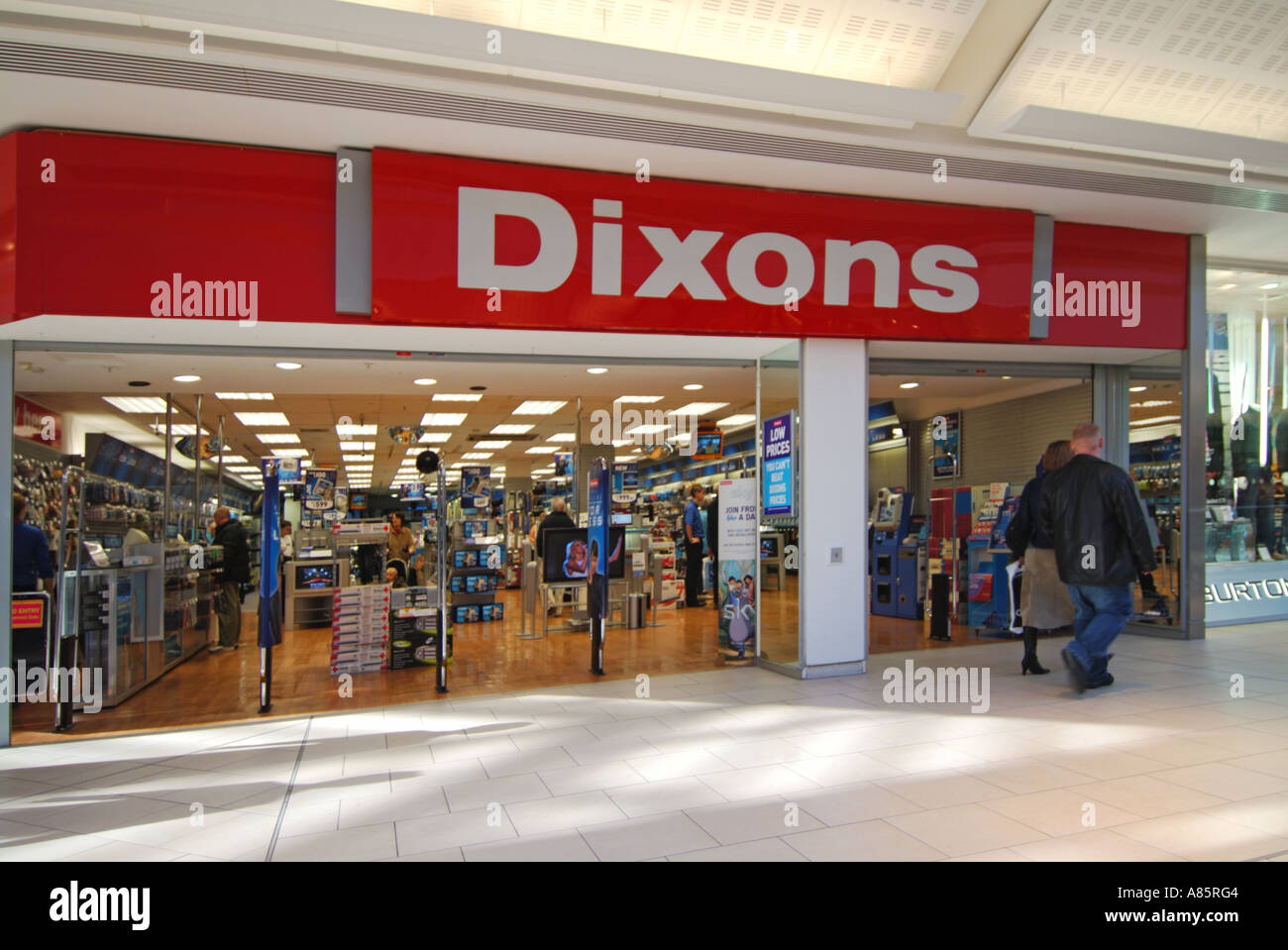 Customers inside Dixons Retail technology store & shop front entrance directly from indoor shopping mall in Lakeside shopping centre Thurrock Essex UK Stock Photo