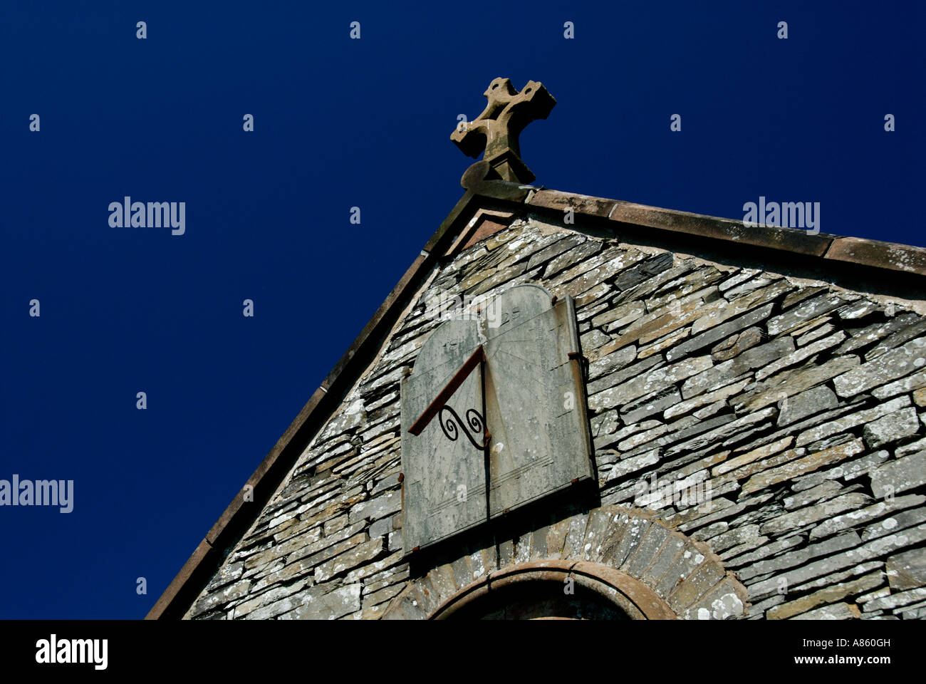 Sundial and cross, Church of Saint Luke, Lowick. Lake District National Park, Cumbria, England, U.K., Europe. Stock Photo