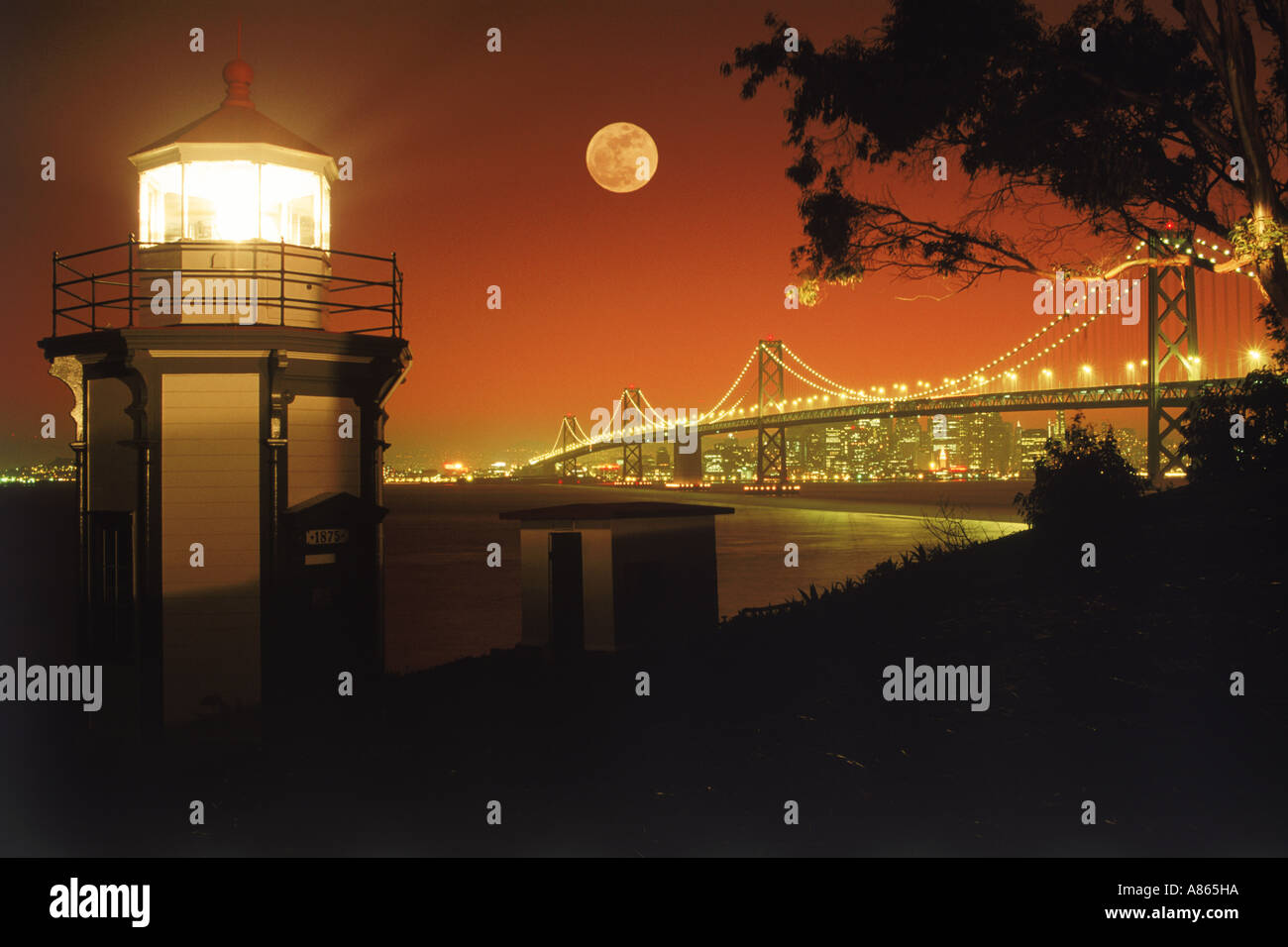 Yerba Buena Lighthouse on Yerba Buena Island with Bay Bridge and San Francisco skyline under full moon Stock Photo
