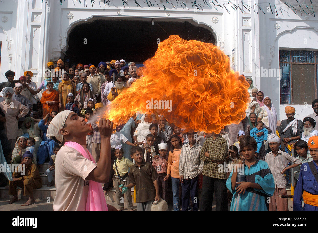 Man performing art of blowing fire from his mouth at Baba Bakala a small town in the Amritsar district of Punjab Stock Photo
