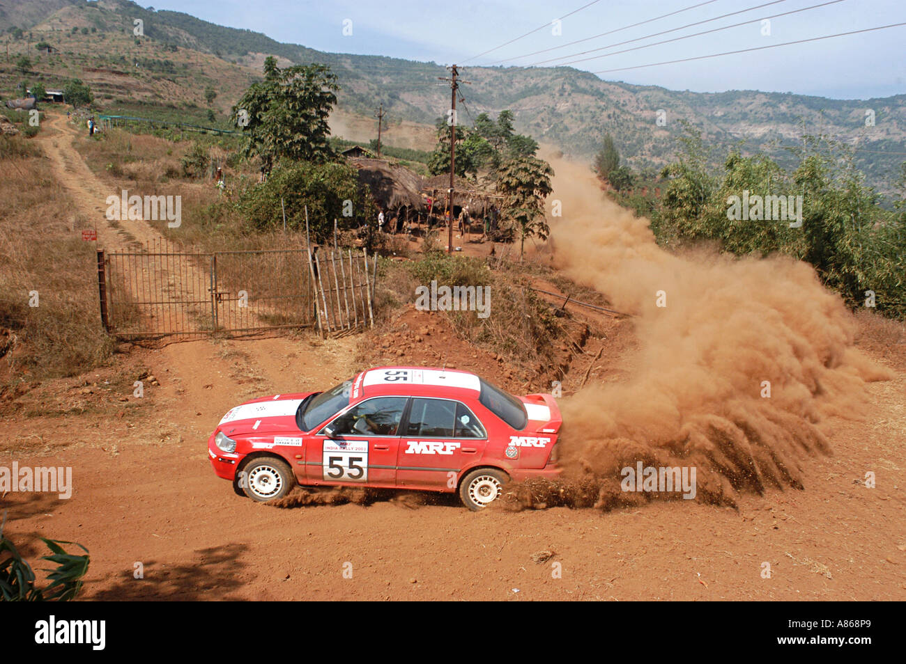 Racing car passing through dusty roads Stock Photo