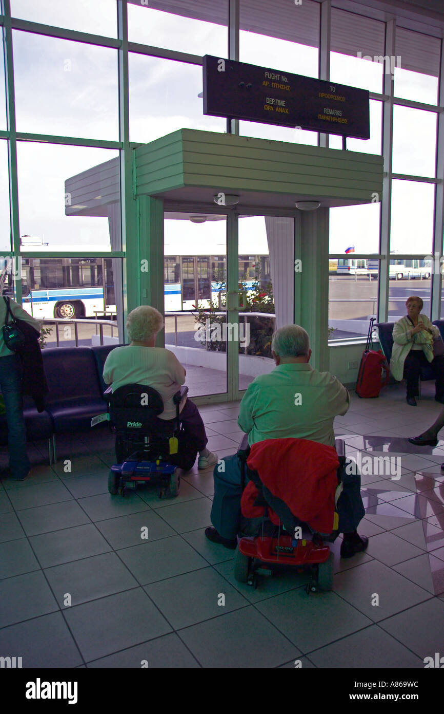 disabled couple waiting to board an aeroplane Stock Photo