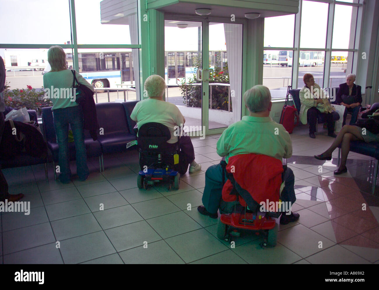 disabled couple waiting to board an aeroplane Stock Photo