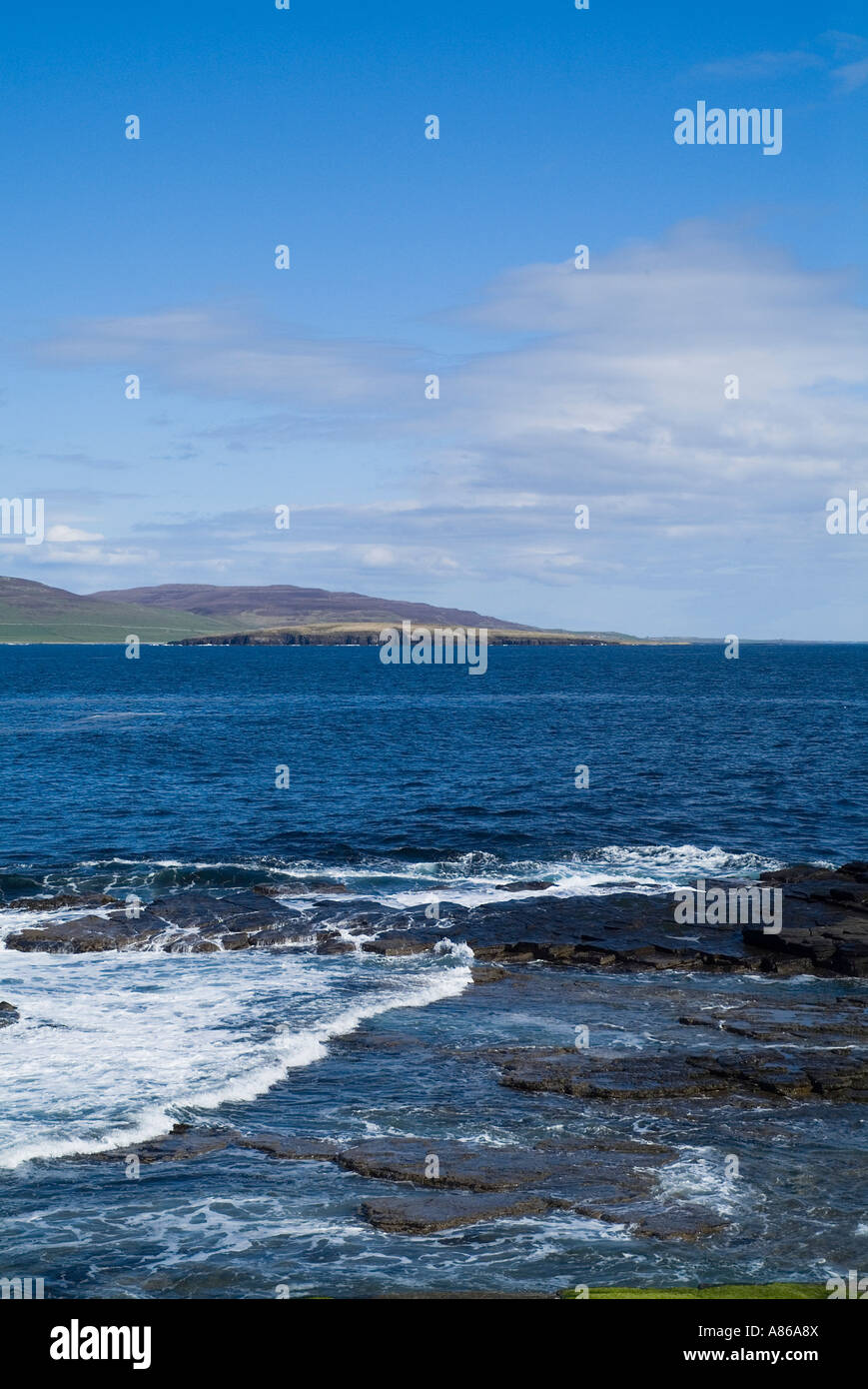 dh Eynhallow Sound EVIE ORKNEY Waves ashore seacliff shelf blue sea and Rousay island coast rugged water Stock Photo