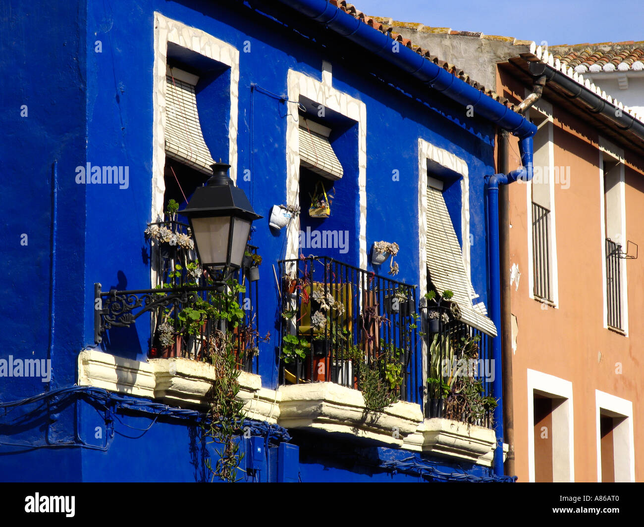 Villagestreet with striking blue house in Spain Stock Photo