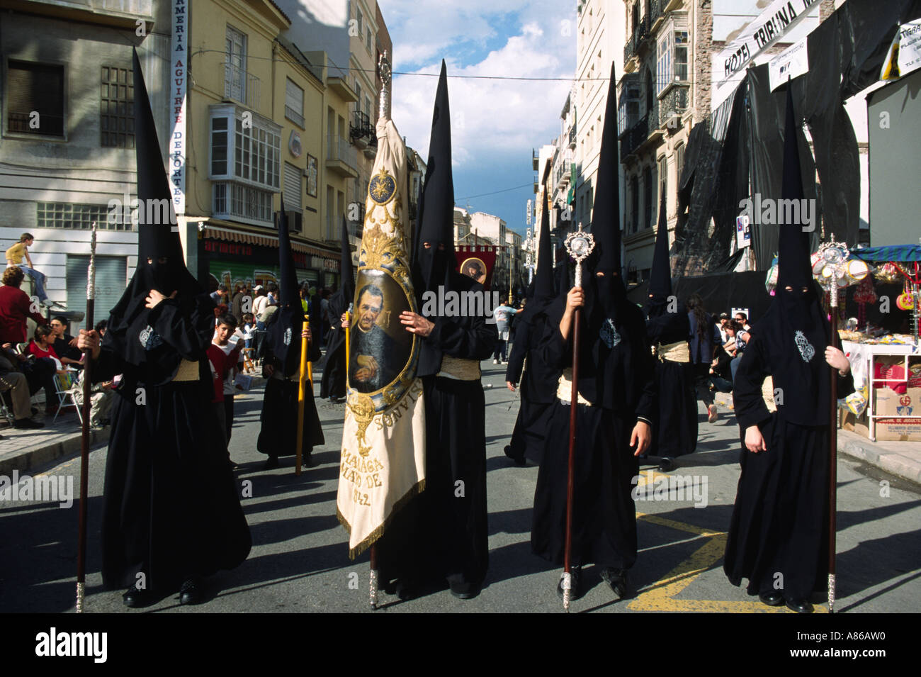 Easter procession in Spain men in black walking in a street Stock Photo