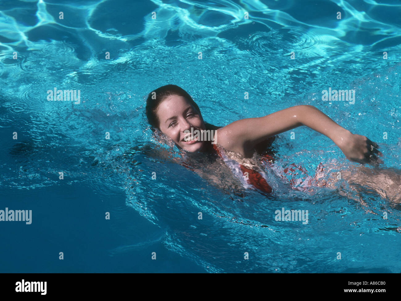 attractive young woman swimming in pool Stock Photo
