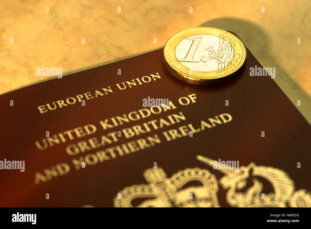 British European Union passport with 1 Euro coin Stock Photo