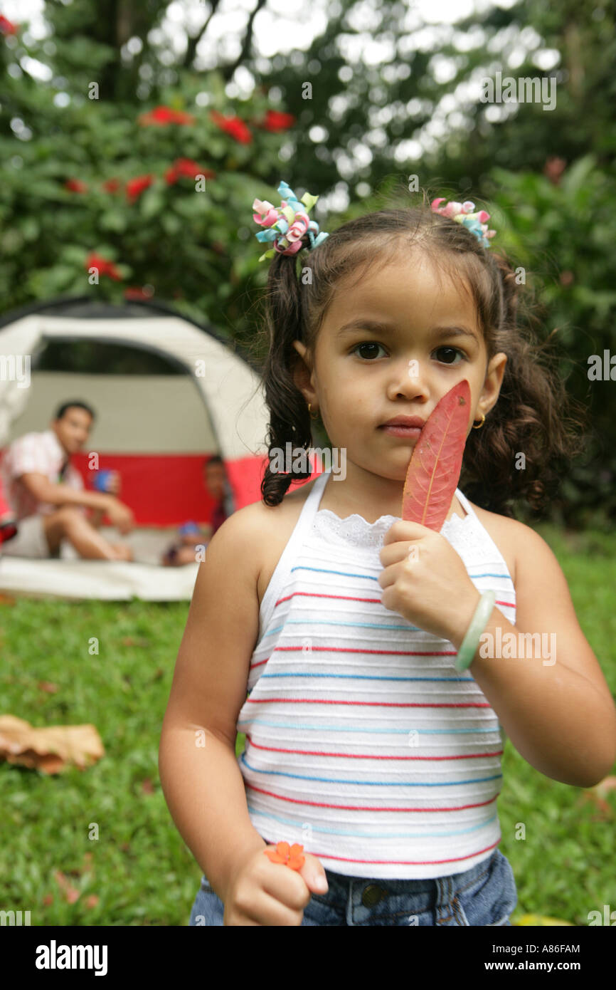 Portrait of girl holding leaf and flower Stock Photo - Alamy