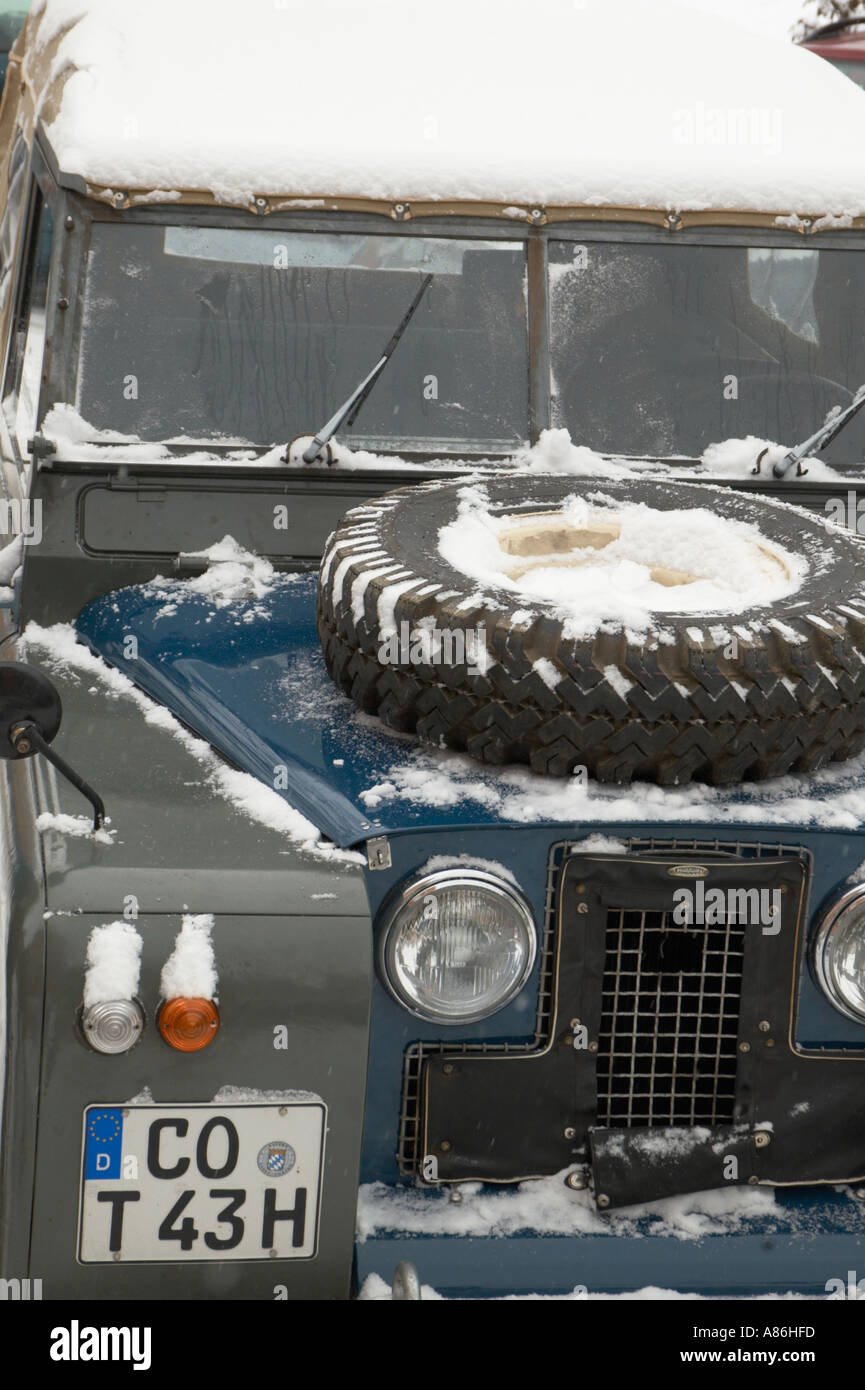 Close up onto a snow covered 1965 Land Rover Series IIa short wheel base softtop on a winter journey through Thuringia, Germany. Stock Photo