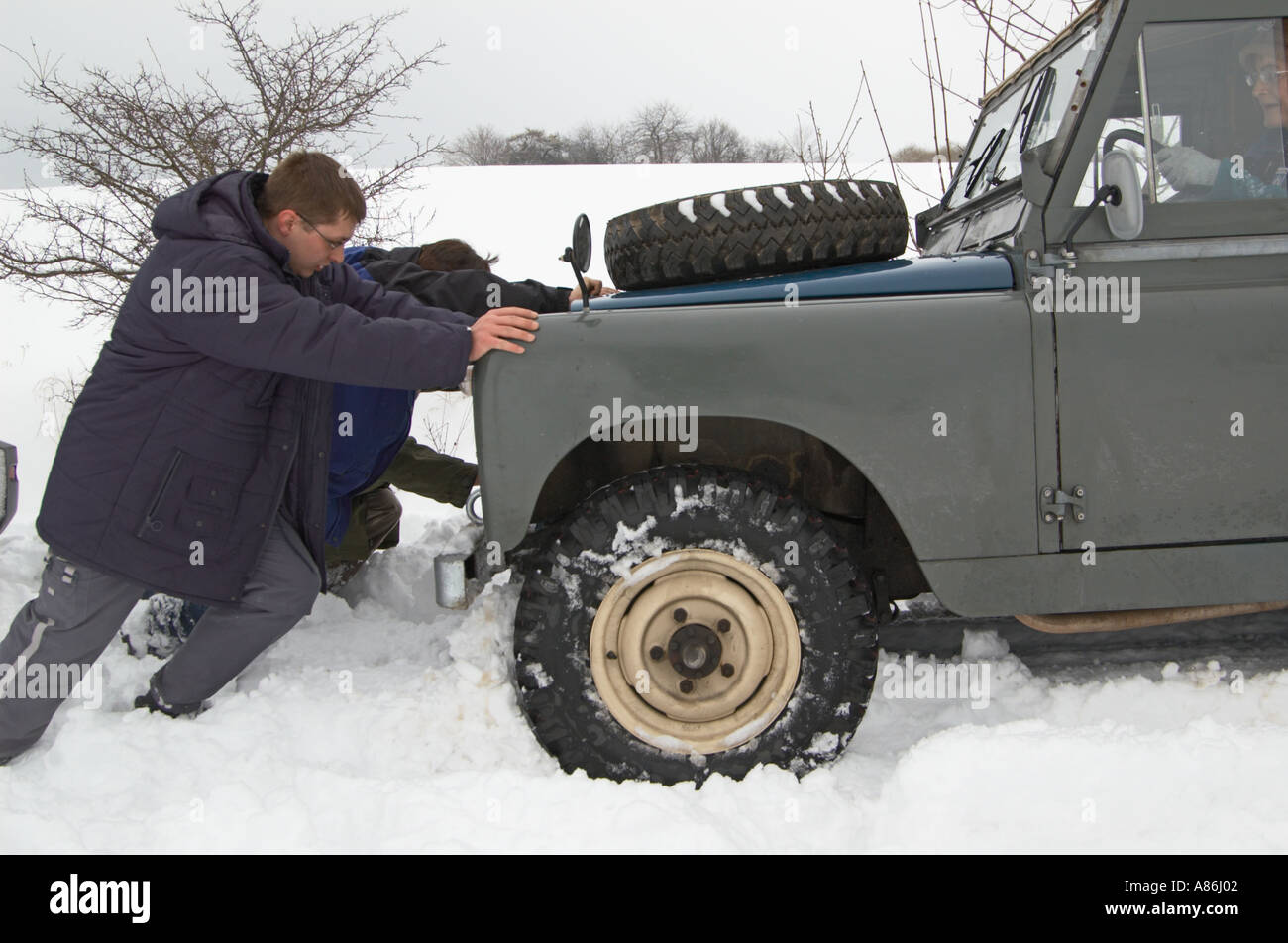 Recovering a 1965 Land Rover Series IIa short wheel base softtop stuck in snow. Germany, Thuringia 2005. HGW DE0500096. Stock Photo