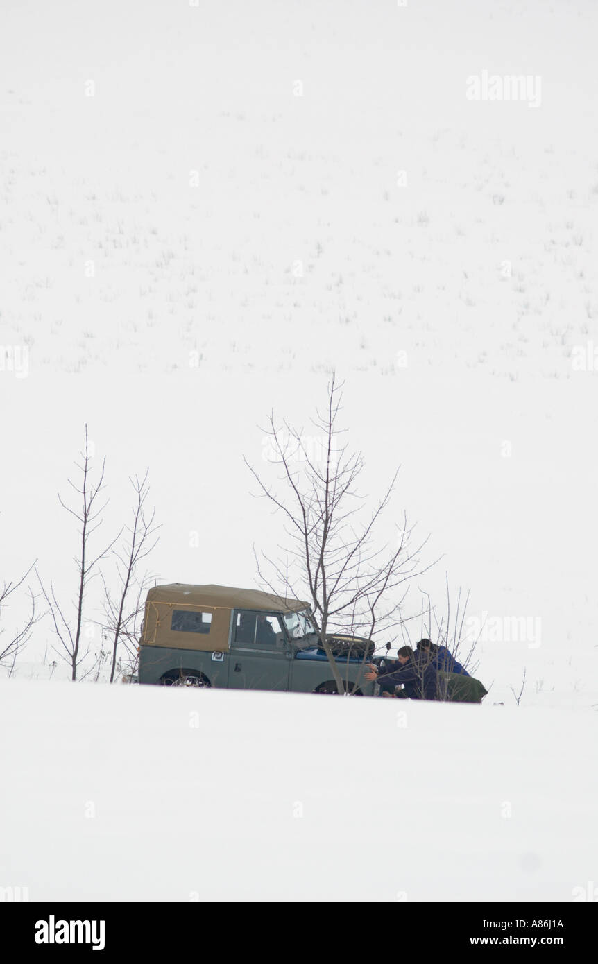 Recovering a 1965 Land Rover Series IIa short wheel base softtop stuck in snow. Germany, Thuringia 2005. HGW DE050120. Stock Photo