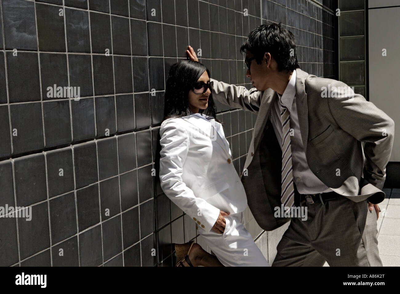 View of two colleagues standing against a wall. Stock Photo