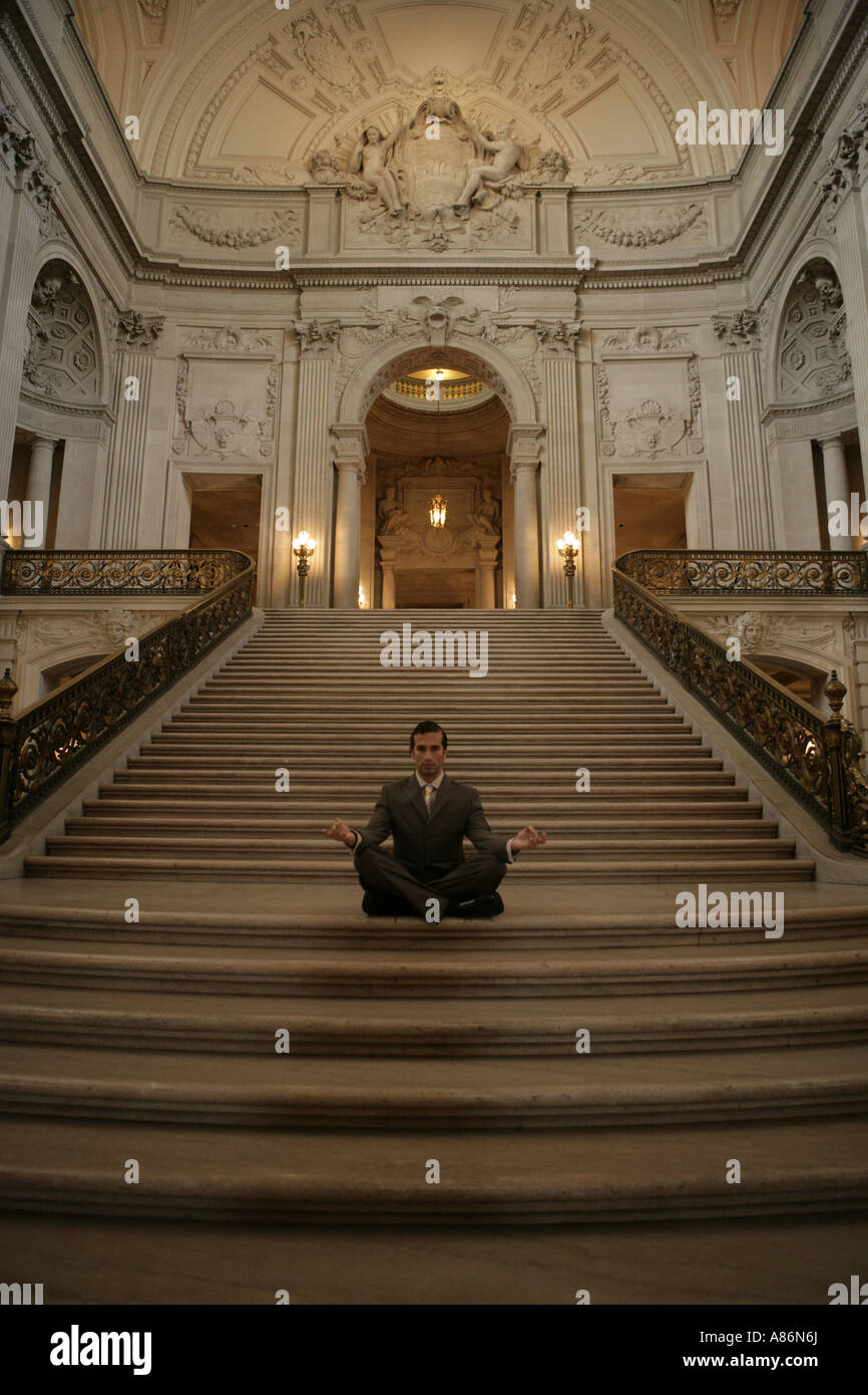 View of a businessman meditating Stock Photo - Alamy