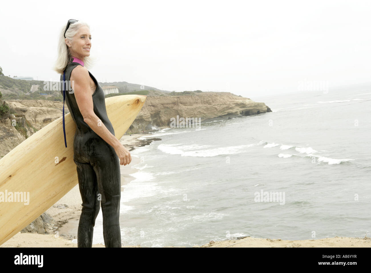 Mature woman surfing surfboard hi-res stock photography and images - Alamy
