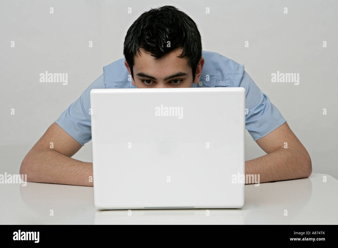 View of a teenage boy working on a laptop Stock Photo - Alamy