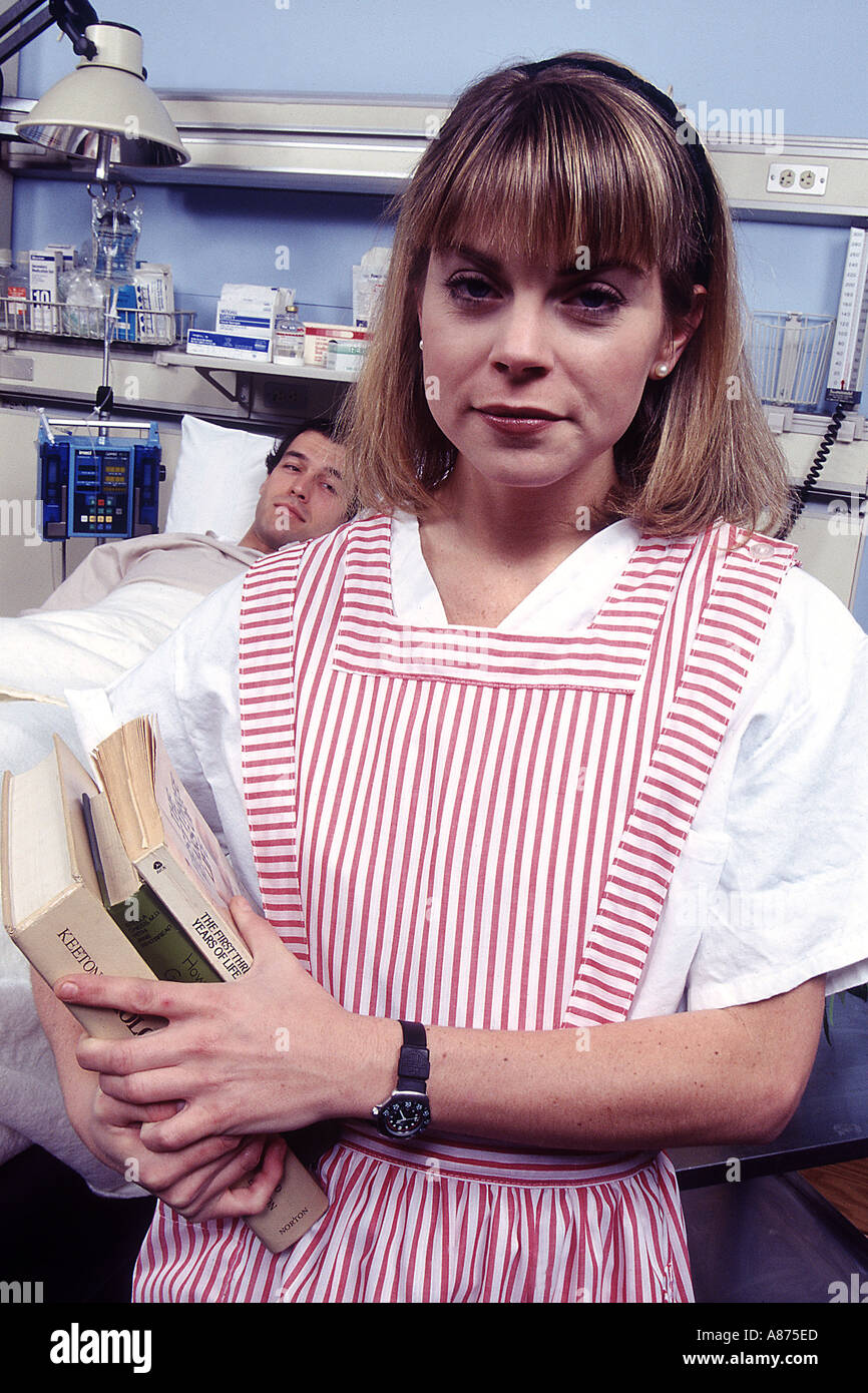 Young woman volunteering (candy striper) at hospital Stock Photo