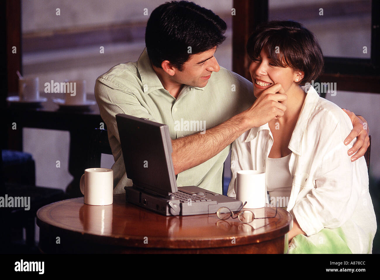 Couple playfully working together. Stock Photo