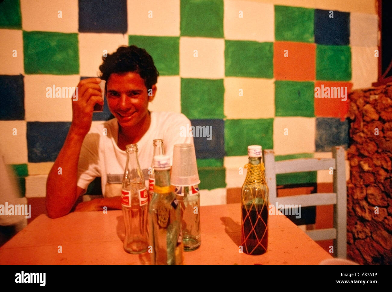 Dominican man drinking rum and coke in a bar in El Castillo Dominican