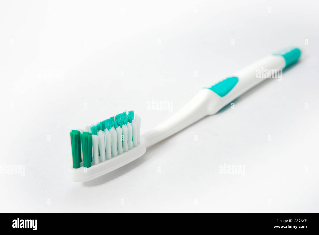Green and white toothbrush on white background Stock Photo Alamy