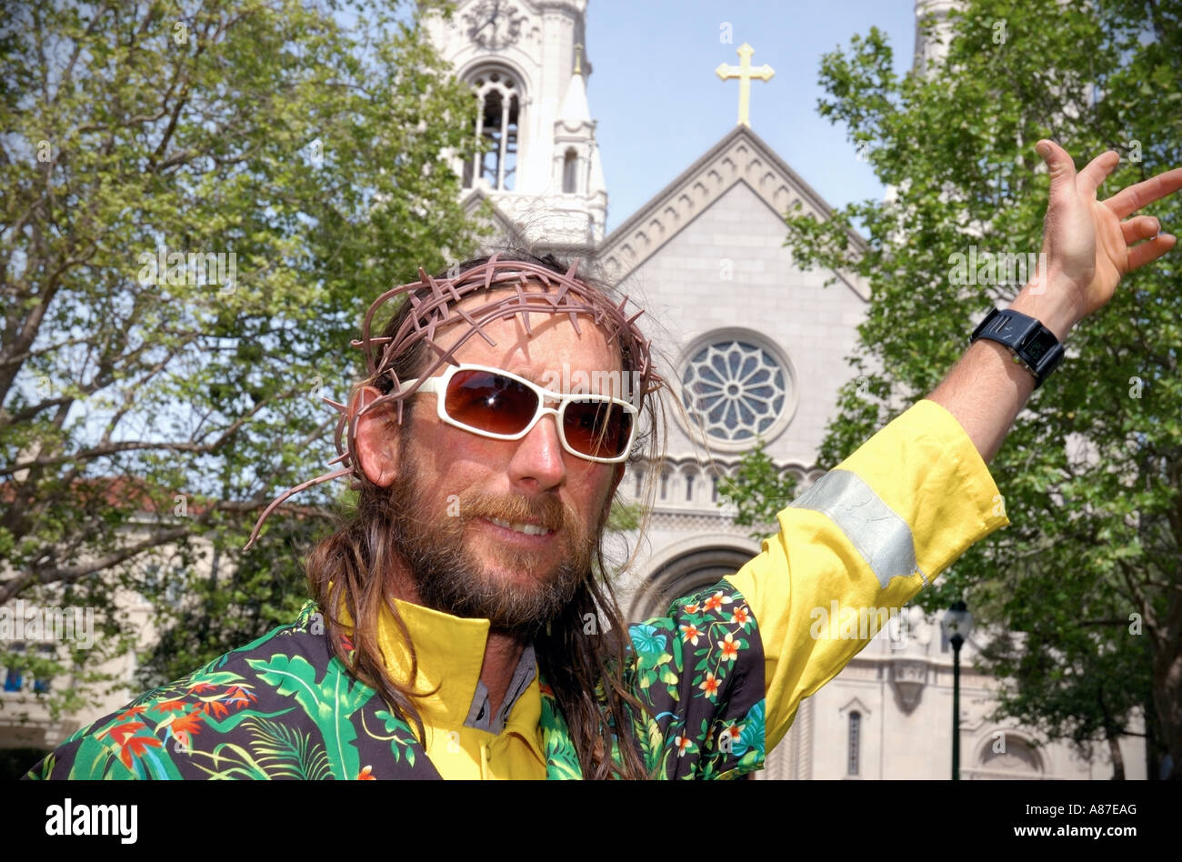 Street performer portraying Jesus poses in front of St. Peter and Paul Church, San Francisco California Stock Photo