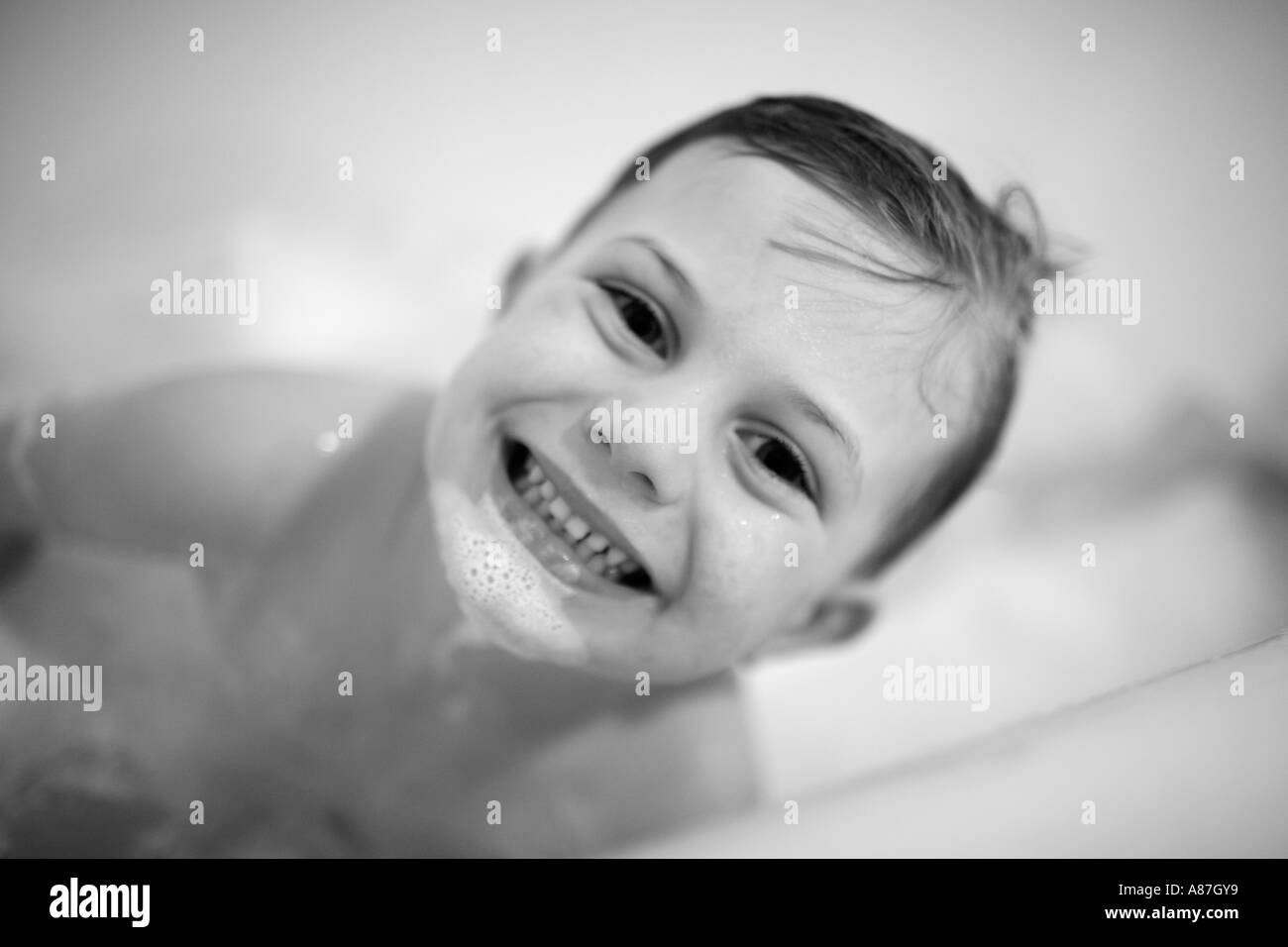 Child in tub taking bubble bath Stock Photo Alamy