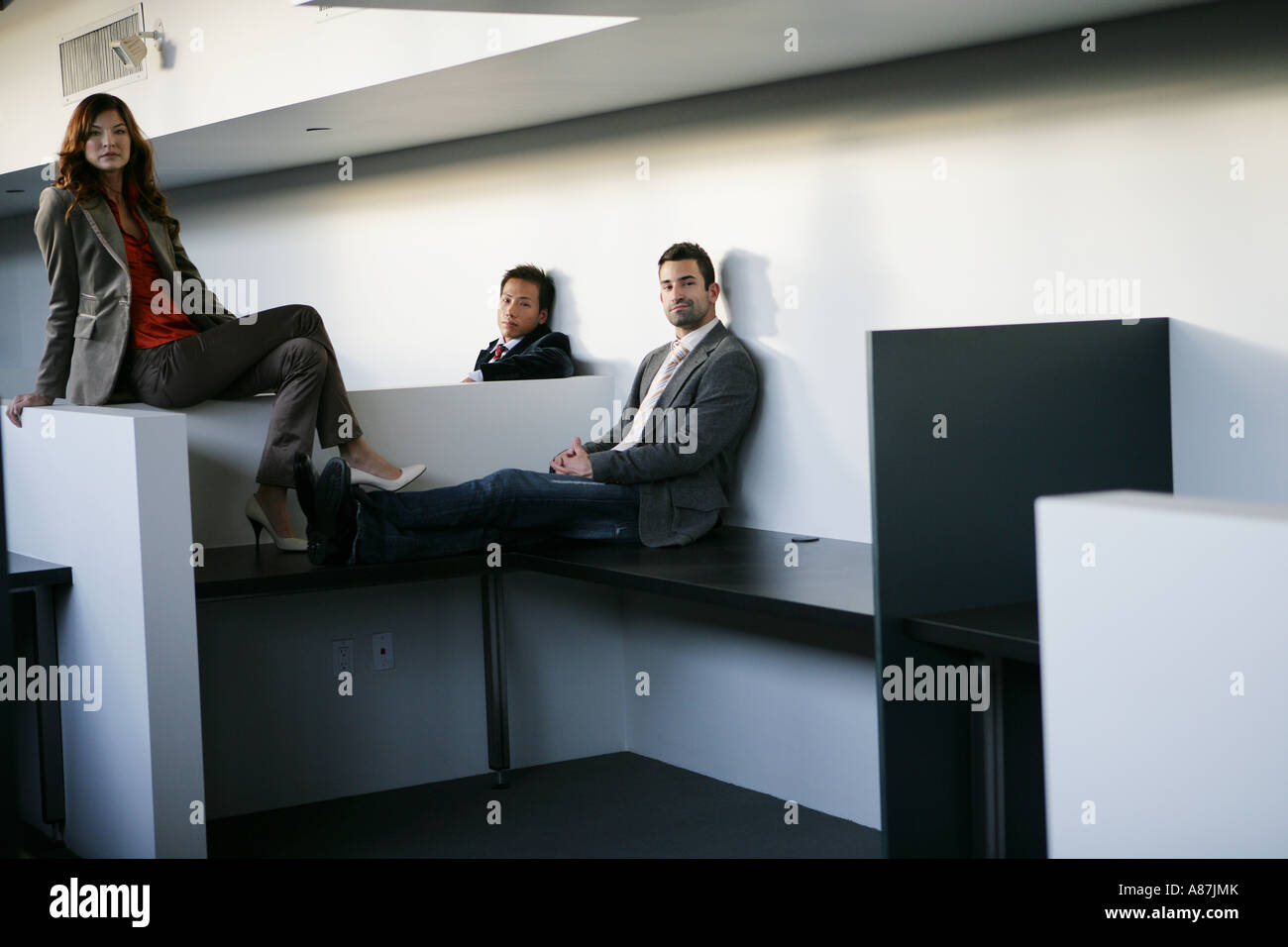 Three male office workers desks hi-res stock photography and images - Alamy