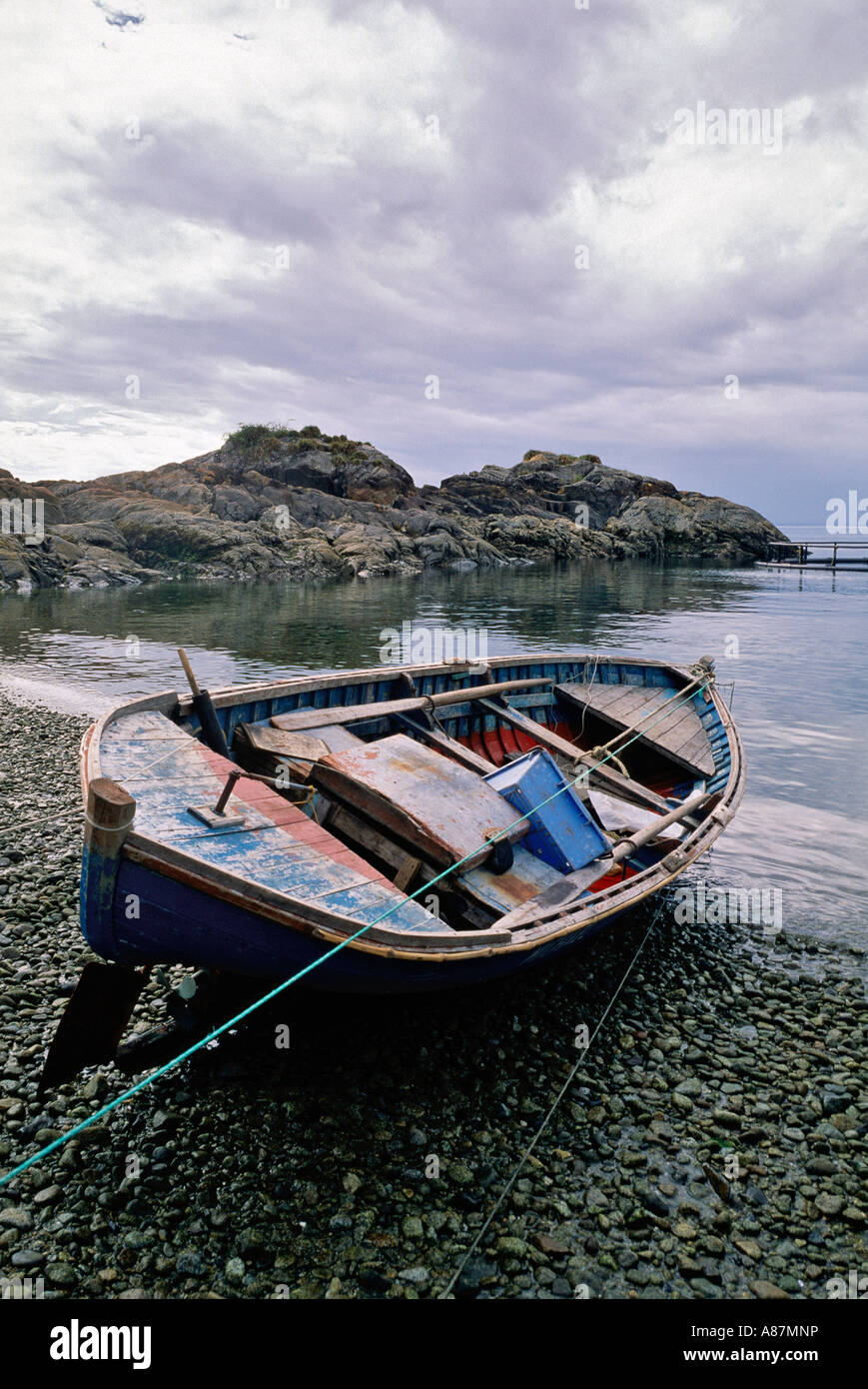 Rowboat on a rocky beach La Arena Patagonia Stock Photo