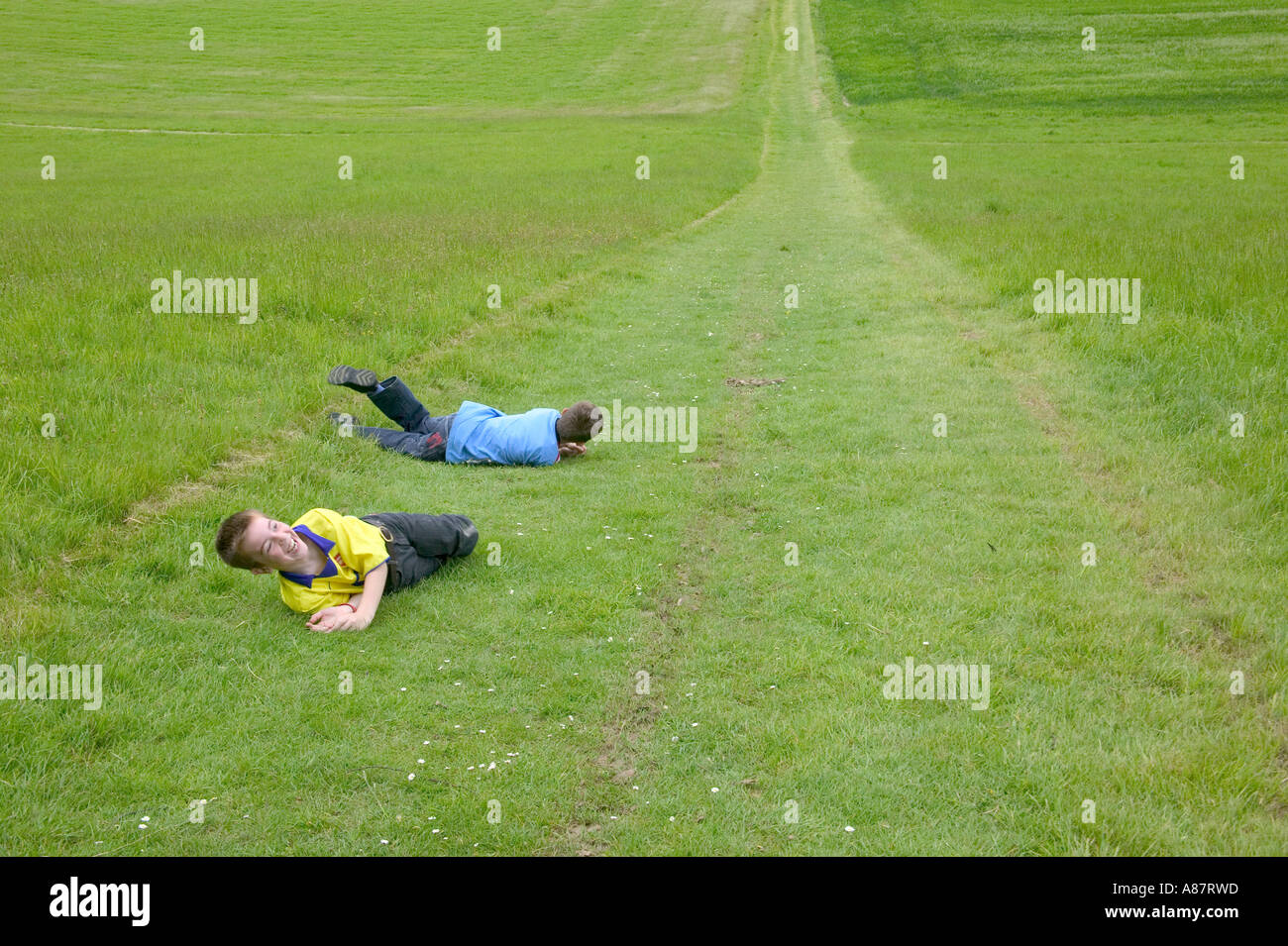 Children rolling down hill Stock Photo - Alamy