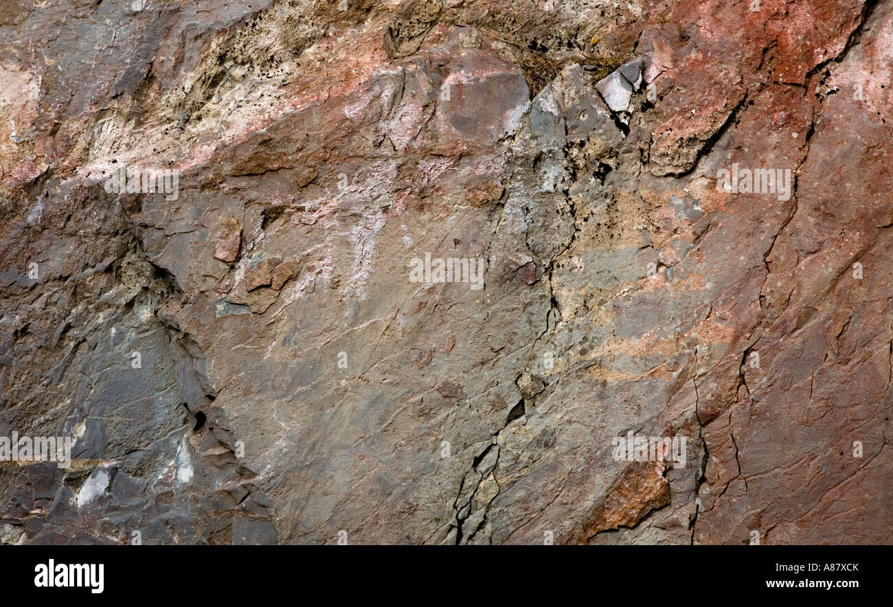 Highly textured and discoloured rock face Stock Photo - Alamy