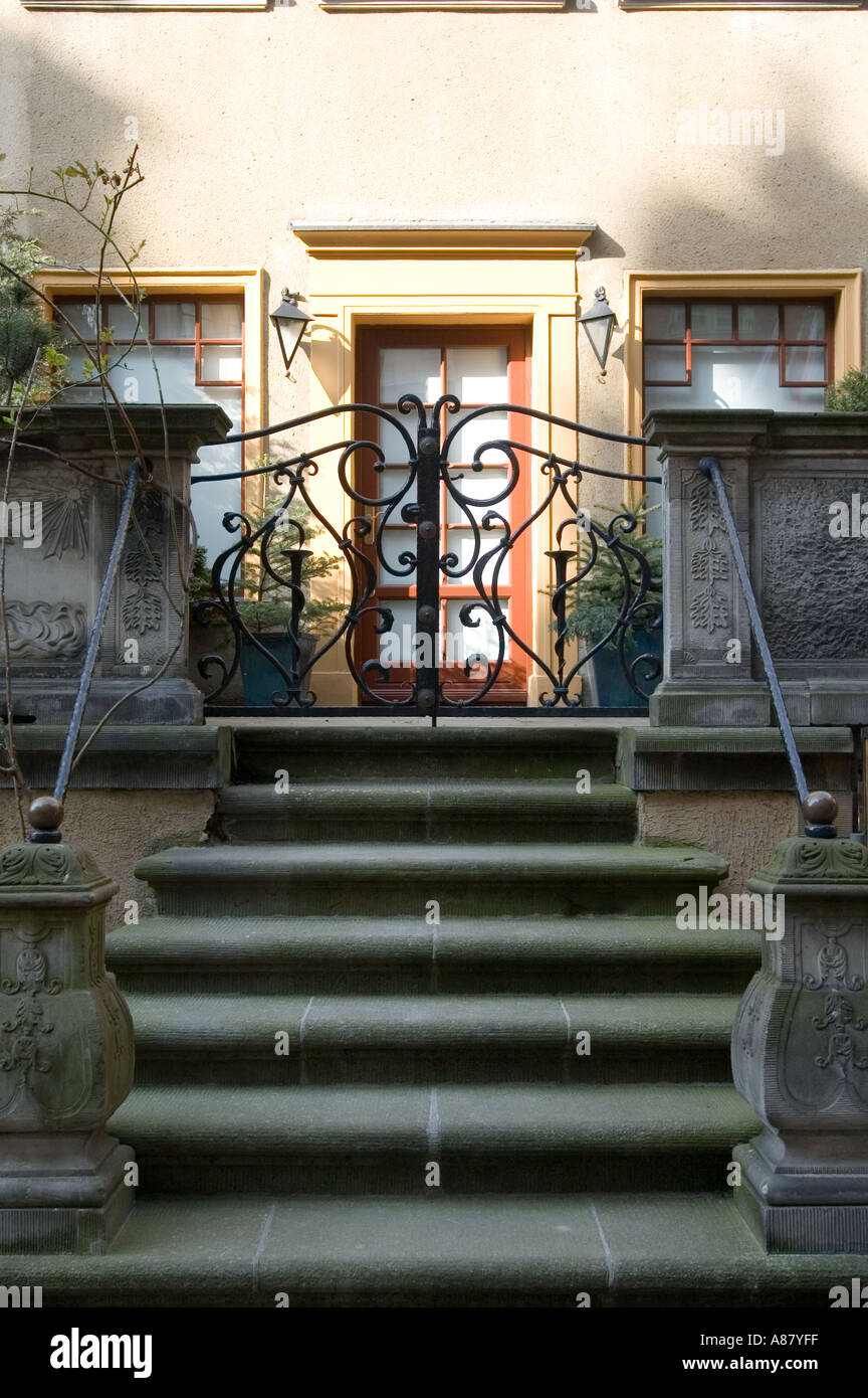 Stone steps and ornate wrought iron gate leading to a historic building ...