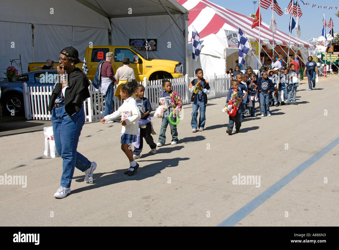 Field trip with elementary school children attend and enjoy the Florida State Fair in Tampa Florida FL Stock Photo