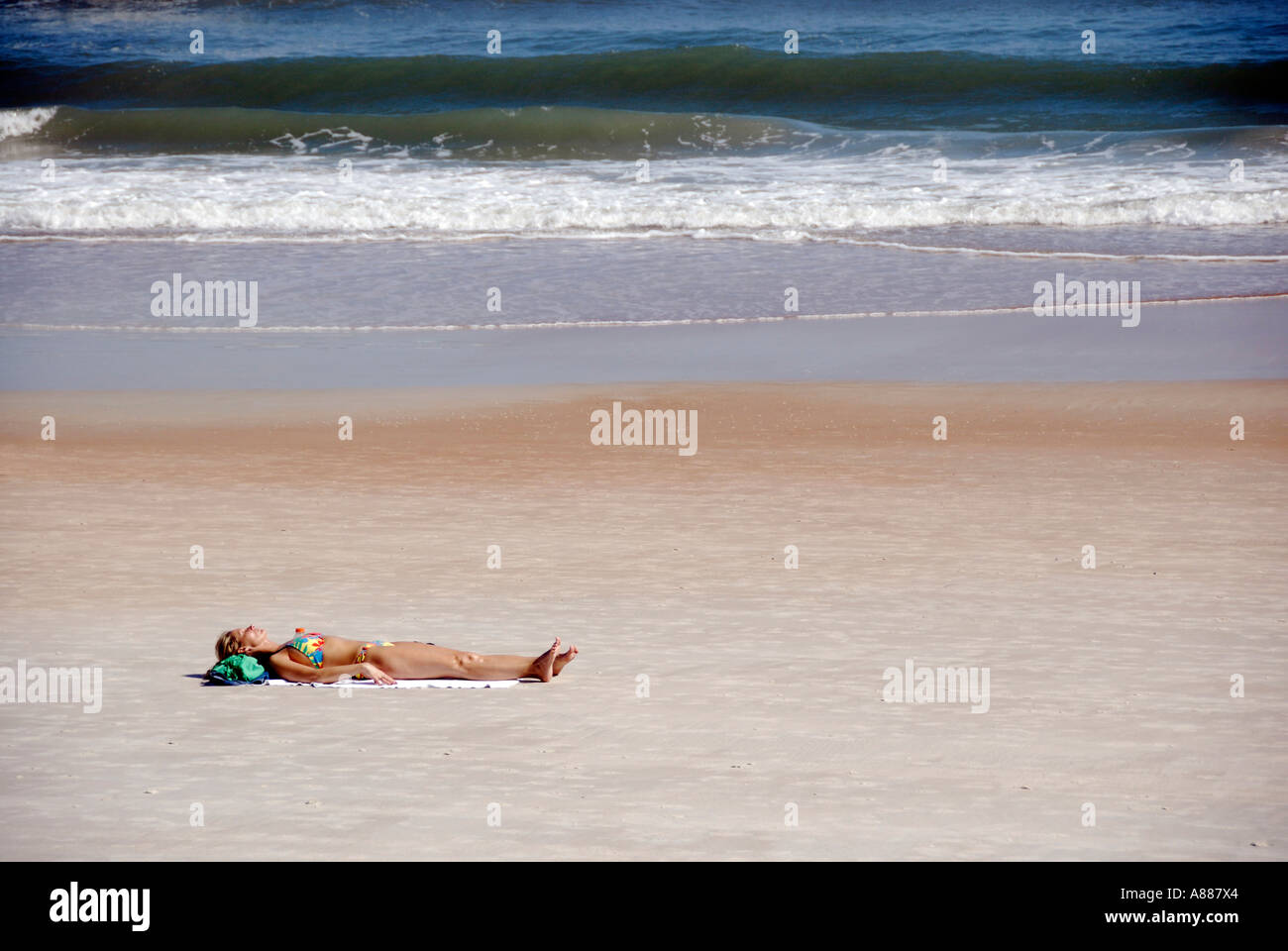Sun tan worshiper laying relaxing on the beach at Daytona Beach Florida