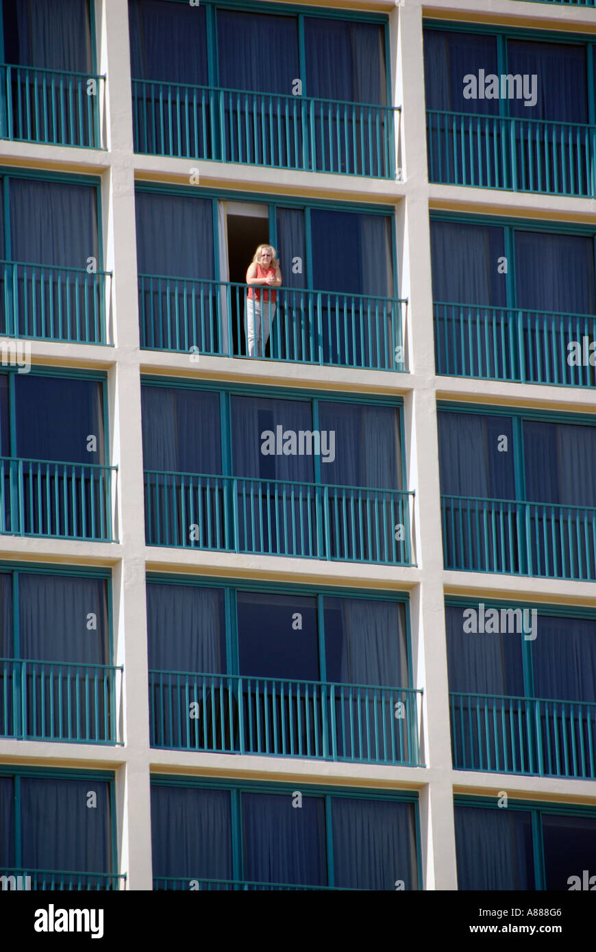 Person standing on a balcony of a high rise condominium condo motel on the beaches of Daytona Beach Florida FL Stock Photo